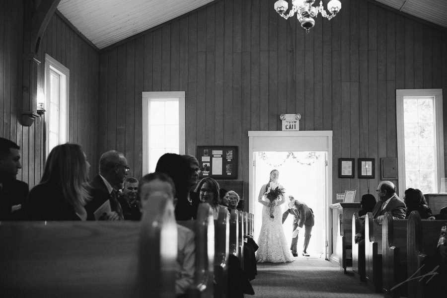 Bride enters wedding ceremony at Yosemite Valley Chapel